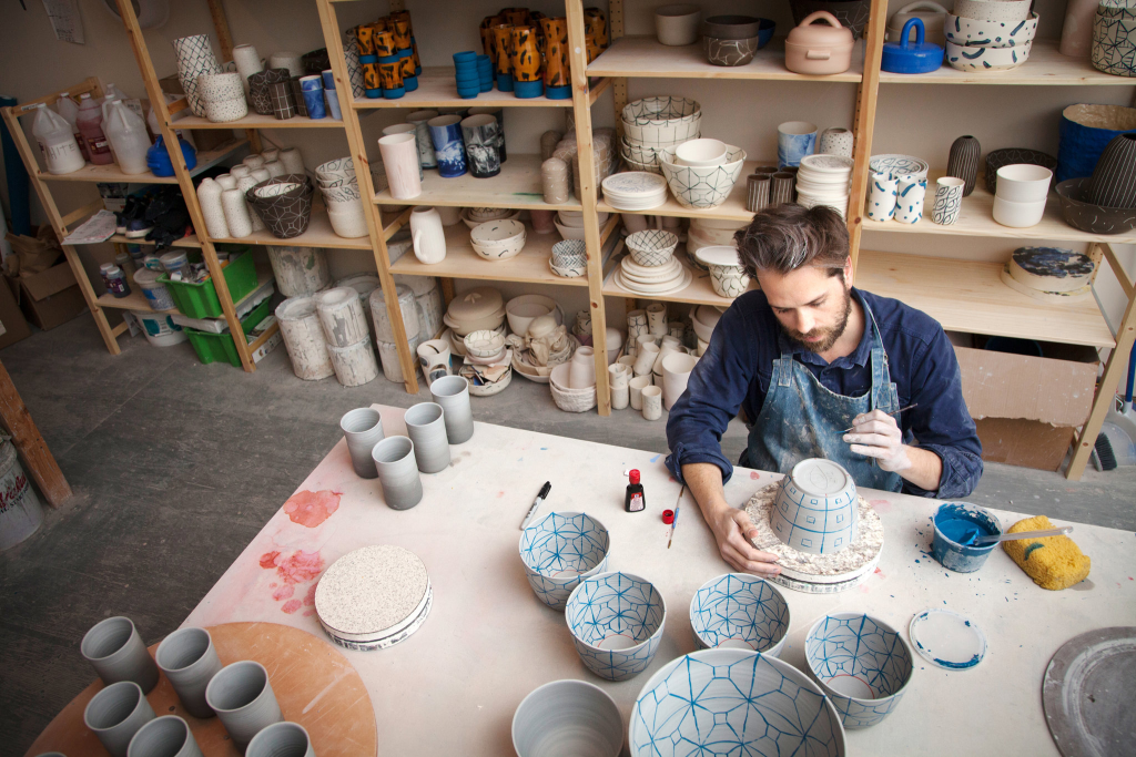 An artist making handcrafted pottery
